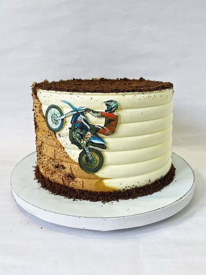 For the thrill-seeker, this dirt bike cake features an edible image of a rider in action against a backdrop of buttercream "dirt" and chocolate crumb soil. It's a great way to celebrate a love for motorsports.
