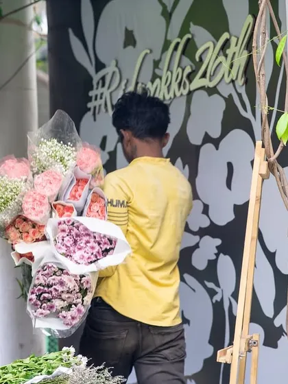 Transporting bouquets to their designated spots. The logistics of a large-scale wedding require a dedicated and hardworking team.