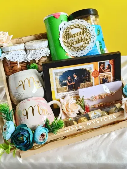 A perfect hamper for your bhai and bhabhi this Rakshabandhan! This beautiful wooden tray is filled with goodies like Mr. and Mrs. mugs, dry fruits, snacks, and a personalized photo frame to celebrate their bond.