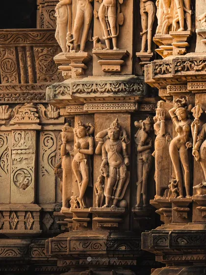 A detailed shot of the intricate carvings on the walls of the Khajuraho temples, showcasing the incredible craftsmanship of ancient India.