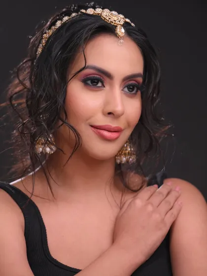 This pose highlights the traditional jewelry paired with a modern makeup and hair look.