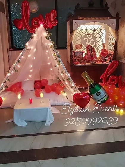 I can transform any room into a romantic retreat for an anniversary or proposal. This cozy canopy tent setup includes warm fairy lights, red heart-shaped balloons, and soft bedding to create an intimate and memorable surprise.