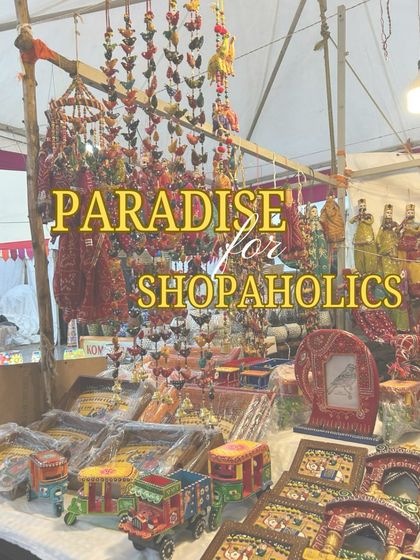 A stall at Dastkar Bazaar filled with handcrafted toys and decor. I provide the basic tent and table structure, creating a 'paradise for shopaholics' by bringing numerous artisans together in one organized space.