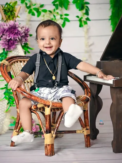 A duplicate of image 94, a happy toddler enjoying his birthday shoot.