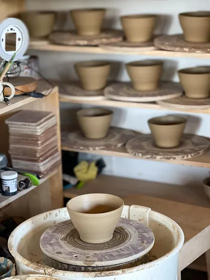 These bowls are waiting their turn for the kiln. Each one was thrown with care to ensure consistency across the entire order.