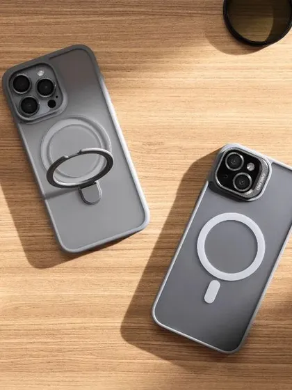 A lifestyle flatlay of tech accessories on a wooden desk. We arranged the phone cases with other everyday items like an Apple Watch and AirPods to show how they fit into a modern, connected lifestyle.