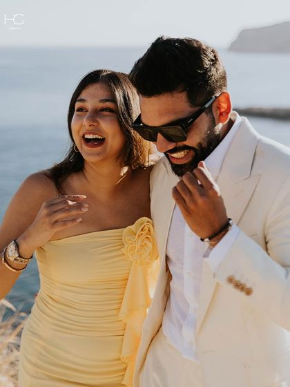 Laughter and sunshine. The white suit, seen here in a moment of joy, is a versatile piece for any happy celebration, tailored to perfection.