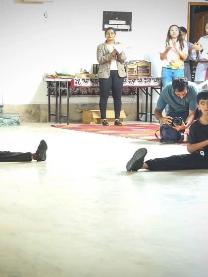 Flexibility is as important as strength. Two young students demonstrate the splits as part of their black belt test, showing their dedication to all aspects of conditioning.