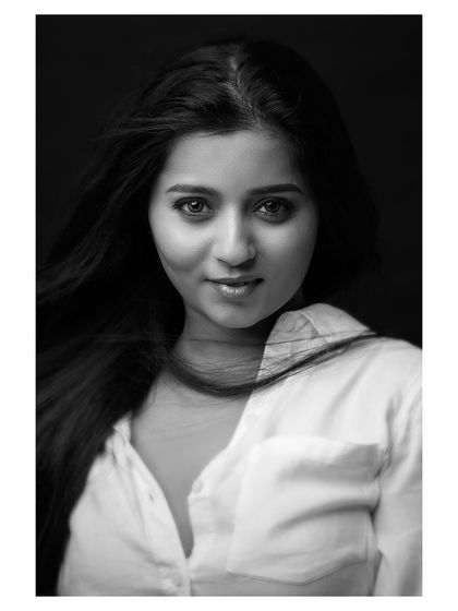 A classic portrait where the wind adds a touch of life. The black and white conversion brings out the texture of her hair and the honesty in her expression, resulting in a simple yet captivating headshot.