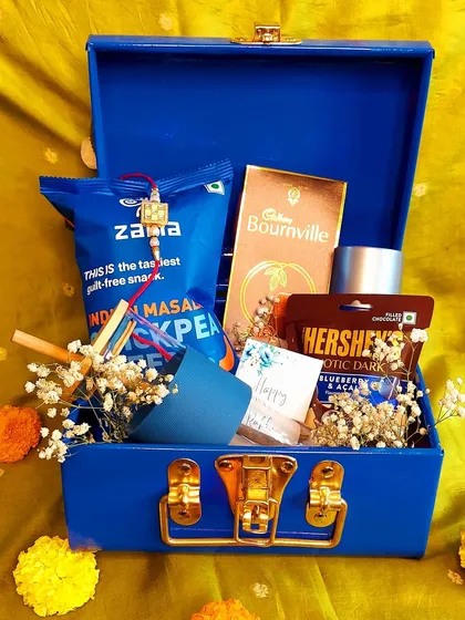 A simple yet thoughtful Rakhi gift for a brother. This mini trunk is filled with his favorite snacks and a small gift, showing that even small gestures can mean a lot.