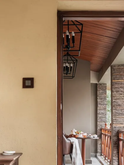 A view from inside looking out onto a private balcony. These small, intimate outdoor spaces are essential in our mountain home designs, providing personal spots to connect with the serene environment.