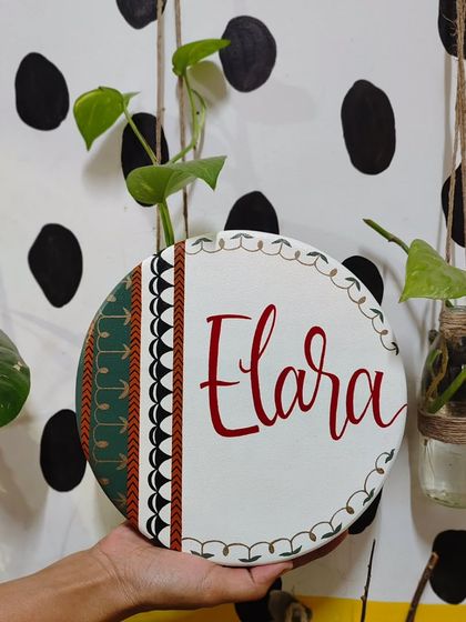 A full view of the "Elara" name plaque, showing how the traditional patterns and colors come together. This piece is a beautiful fusion of heritage and modern design.