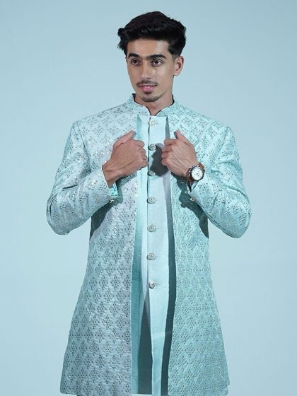 A close-up of the light blue sherwani, showing the intricate embroidery and elegant design.