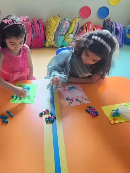 Students are engrossed in their craft activity, using various materials to create unique and personalized cards for their mothers.