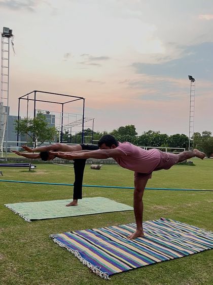 Holding a strong Warrior III pose (Virabhadrasana III), our members demonstrate balance and stability. This yoga asana strengthens the entire back side of the body.