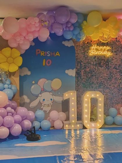 A sweet Cinnamoroll-themed party for Prisha's 10th birthday. The setup uses a pastel blue and pink color scheme with a cloud-like backdrop, character cutouts, and a marquee number '10'.