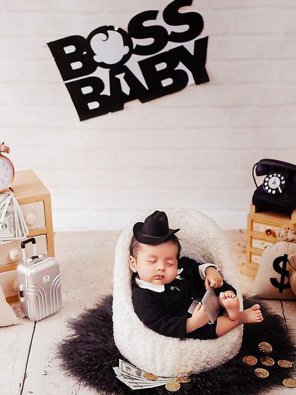 The boss is sleeping on the job. This creative newborn photo is a funny and adorable way to capture your baby's earliest days.