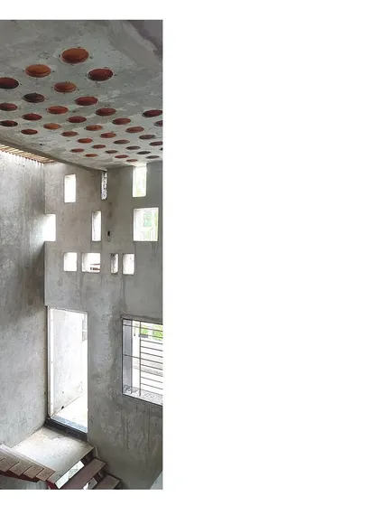 This image from the Mahesh Residence captures a moment where raw structure becomes art. The angular punctures in the concrete wall are not random; they are carefully designed to orchestrate a dramatic play of light and shadow within the home. This technique, combined with a filler slab ceiling, showcases my commitment to using sustainable building materials in poetic and functional ways.