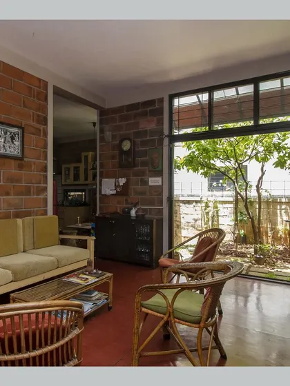 A view of the living room showing its connection to an internal garden, bringing nature right into the heart of the home.