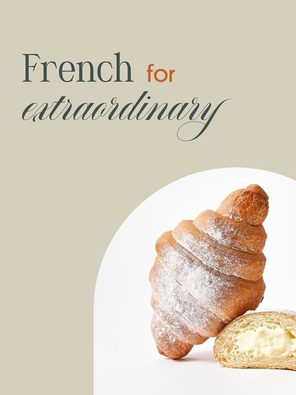 We believe our croissants are French for extraordinary. This image captures a cream-filled variant, showcasing the soft, rich filling that complements the flaky pastry shell.