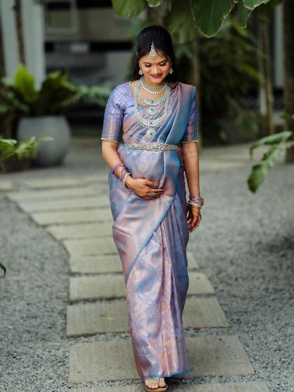 A mother-to-be walks along a gravel path in our garden. The soft, natural light and peaceful surroundings make it an ideal location for a maternity shoot.