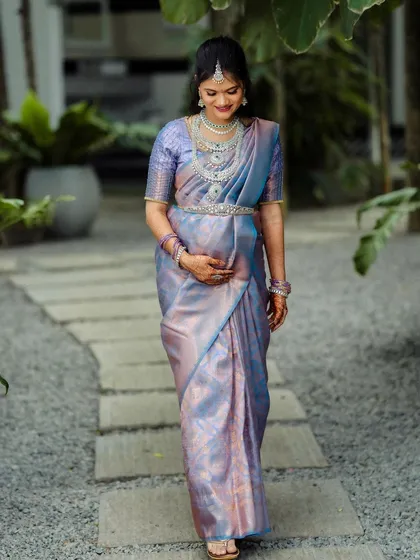 A mother-to-be walks along a gravel path in our garden. The soft, natural light and peaceful surroundings make it an ideal location for a maternity shoot.