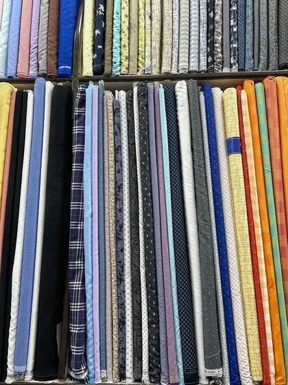 A glimpse into the variety of high-quality fabrics I can bring to your home. This selection includes premium textiles for shirts, kurtas, and trousers in various patterns and colors, allowing you to choose the perfect material for your custom garment.