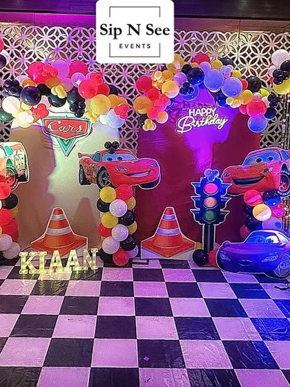 Ready, set, go! This Cars theme party decoration brings the excitement of the racetrack to the celebration. I included a checkered floor, a 'Happy Birthday' neon sign, traffic light props, and of course, cutouts of Lightning McQueen and his friends.