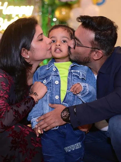 A beautiful moment of parental love. Kisses for the birthday boy make for a priceless memory.