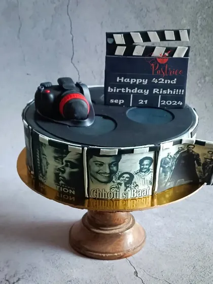 For the ultimate movie lover, I created this film reel cake. It features edible prints of classic movie posters wrapped around a lemon and whole-berry cake, complete with a handmade fondant camera and clapperboard.