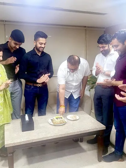 We work hard, and we celebrate our successes as a family. Here, our team celebrates a senior's birthday in the office, reinforcing the strong bonds that make our workplace a supportive environment.