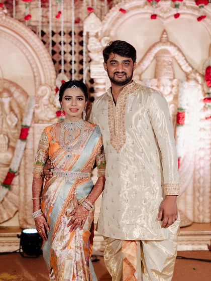 A beautiful family portrait. The couple's coordinated outfits are a testament to our bespoke design service, creating a unified look for their special occasion.