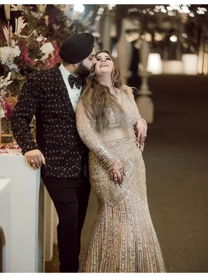 A candid moment of pure joy, with the groom, Gurneet, kissing a laughing Gurbani on the cheek.