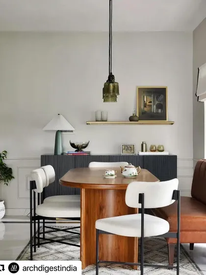 A dining space from the Madras pied-à-terre project by Weespaces, featured in Architectural Digest. We created the sleek, black fluted sideboard with a brass base and the unique dining chairs to fit the home's compact, open-plan design.