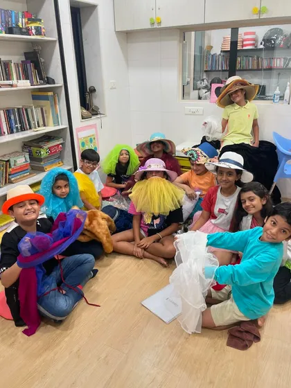 This is the joyful chaos we love. A simple prop like a hat can unlock a world of characters and creativity. This image captures a spontaneous moment of fun and camaraderie in our class, where students are free to experiment and build confidence together.