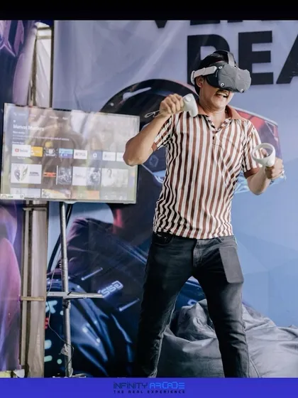 Step into another reality with my VR gaming setup. Here, a player is fully immersed in a virtual world, while the action is shown on a spectator screen so everyone can be part of the fun.