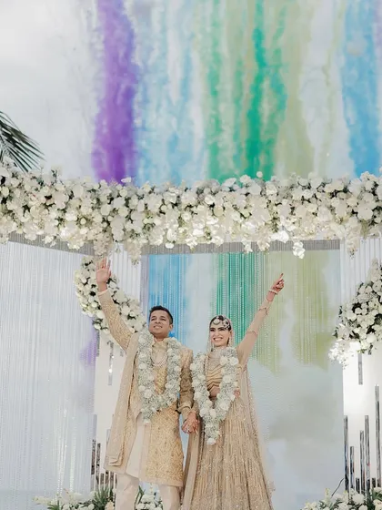 A blast of color to celebrate their union. We used vibrant smoke bombs to create this stunning visual for the couple's Varmala photo at their Goa wedding.
