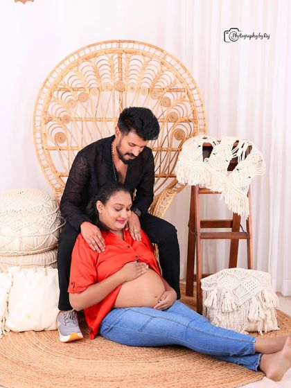 A beautiful family portrait in our bohemian studio, with the older son looking on as his parents share a tender moment.