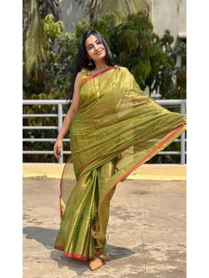 The full view of the mehendi green tissue cotton saree. The light fabric flows beautifully, making you feel graceful and comfortable.