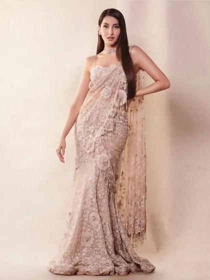 For this look, I dressed Nora Fatehi in a magnificent embroidered saree by Tarun Tahiliani. The intricate detailing and corset-style blouse offer a fresh and glamorous take on classic Indian attire.