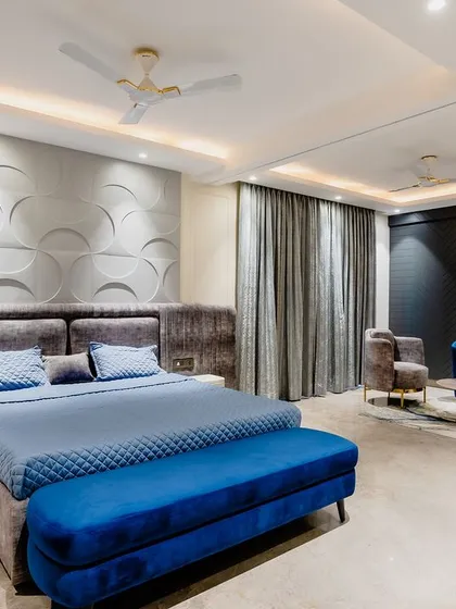 Your bedroom should be your personal sanctuary. For this master suite, we combined a textured 3D panel wall with a rich blue and grey palette to create a space that feels both grand and incredibly calming. It’s where you can truly unwind in style.