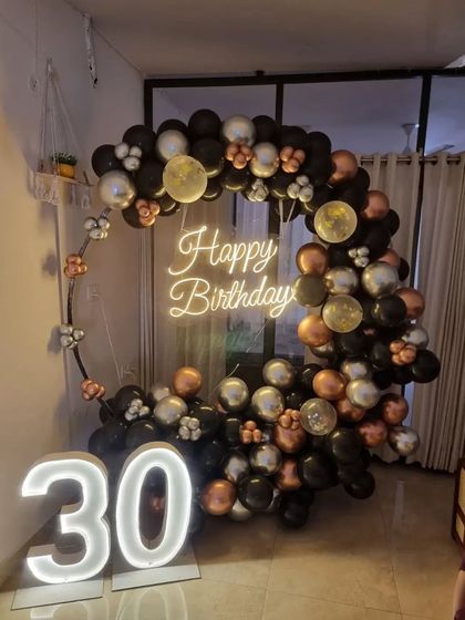 Another angle of the 30th birthday decor, showing the marquee numbers and neon sign.