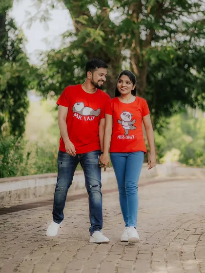 A fun and casual pre-wedding shoot with matching quirky t-shirts. This photo shows the couple's playful side as they walk hand-in-hand.