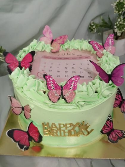 The calendar cake in a styled setting with small plants.