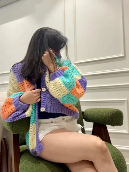 A chunky, color-blocked cardigan that feels like a warm hug. The oversized fit and soft pastel blocks of purple, orange, and aqua make this a go-to piece for ultimate comfort and style.
