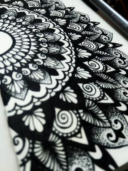 Another perspective on the semi-mandala, showing the crisp black ink on the page. This kind of detailed work is incredibly calming and is a core skill I teach in my beginner workshops.