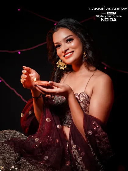 A classic Diwali portrait with a diya. The makeup is warm and golden, reflecting the light of the lamp and the spirit of the festival.