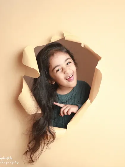 Pointing to the fun! Her long hair and happy expression are the focus of this dynamic shot.