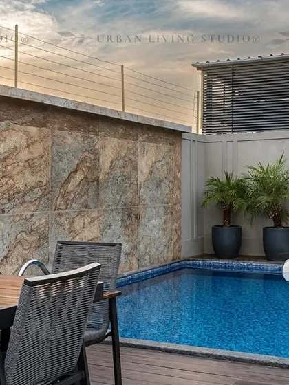 A private rooftop pool we designed and built for a residence in Aligarh. The space includes a natural stone feature wall and a comfortable dining area, proving that even urban homes can have their own exclusive resort-like amenities.