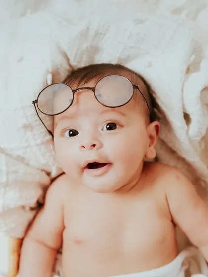 A little scholar in the making. The round glasses add a playful and adorable touch to his milestone photos.